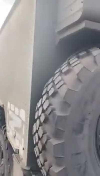 A captured Russian seperatist and a Z marked Russian vehicle