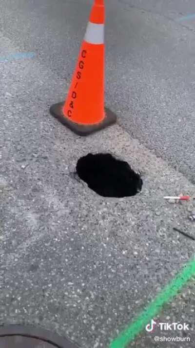 A guy climbs into a sinkhole in my hometown.