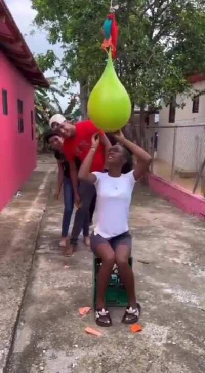 Taking turns cutting balloons until someone gets to the water filled one