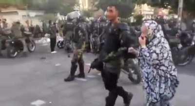 The mother of one of the security forces comes after her son to take him home. (Iran Revolution 2022)