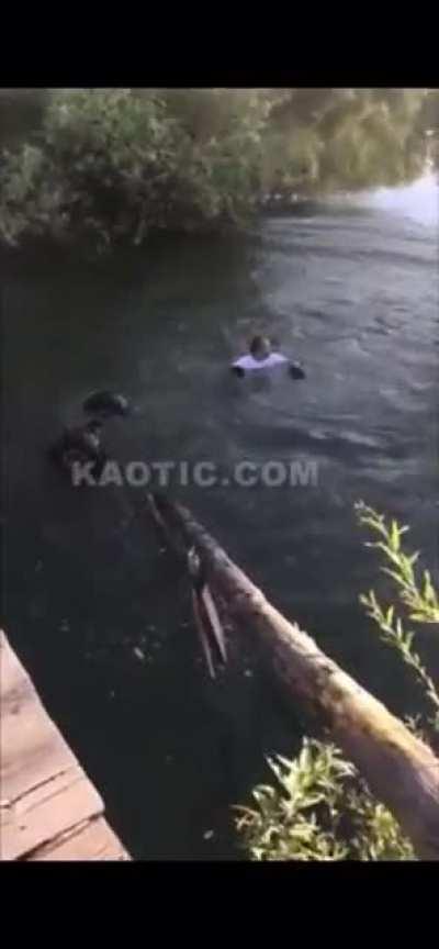 Russian does a burnout on an ATV on an old bridge. Ends up driving off of it.