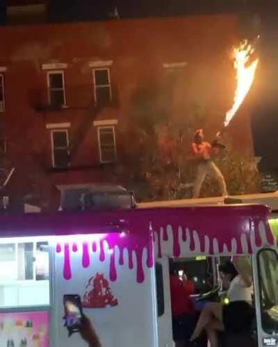 Man climbs on top of a NYC bus and fires a flamethrower.