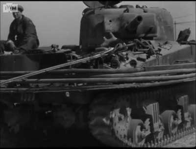 Burned out Sherman DD being towed away for salvage in Normandy on June 24th 1944