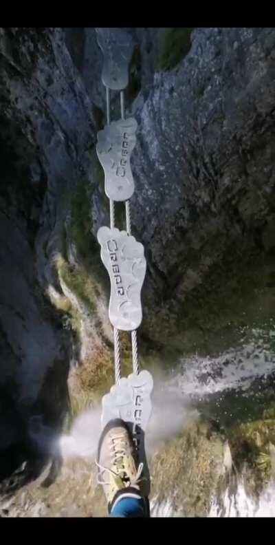 This walking bridge across a chasm in the Ferrata Signora delle Acque, Italy.