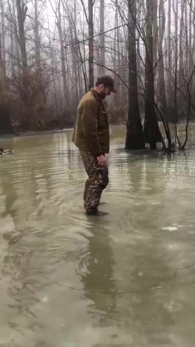 Duck hunter left his gun by the tree