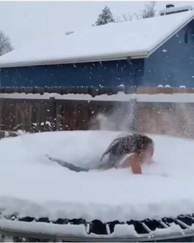 Backflip on a snowy trampoline