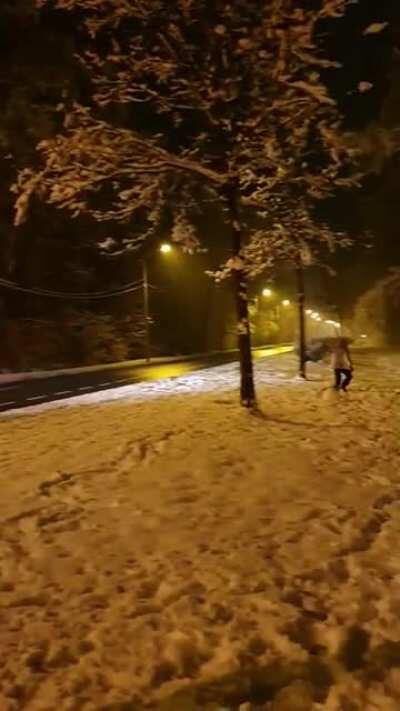Police officers assault kids that are fighting with snowballs