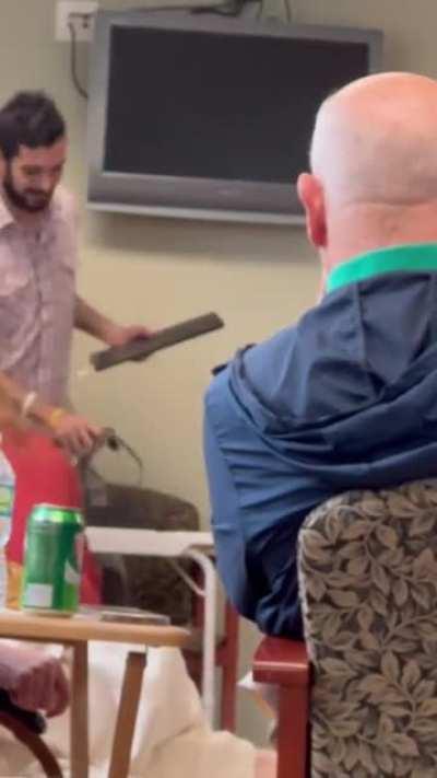 This specimen holding a zoom call in a waiting room with patients waiting for chemotherapy