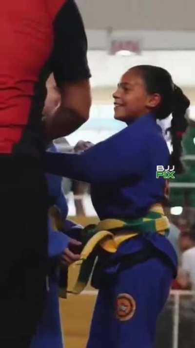 Little girl wins but then celebrates with her opponent. True sportsmanship and kindness! They're both winners!