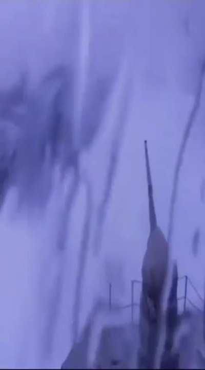 Large wave blasts bridge of warship.