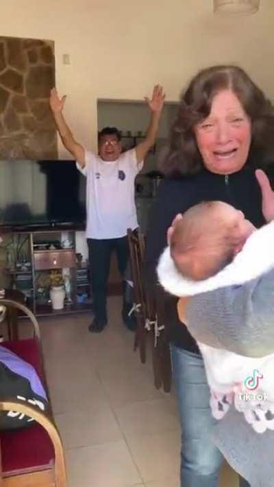 Grandparents see the newborn for the first time