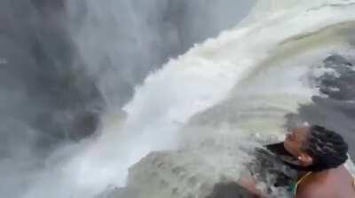 Swimming close to the edge of a 120m waterfall