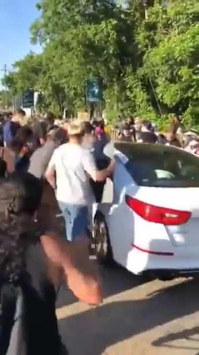Guy at protest smashes a window onto a 1 year old