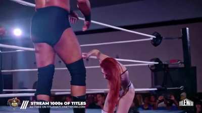 Kelsey Raegan has the rope bumped into her crotch by her male opponent