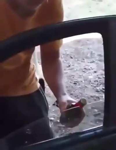 Opening a beer bottle using the car’s window