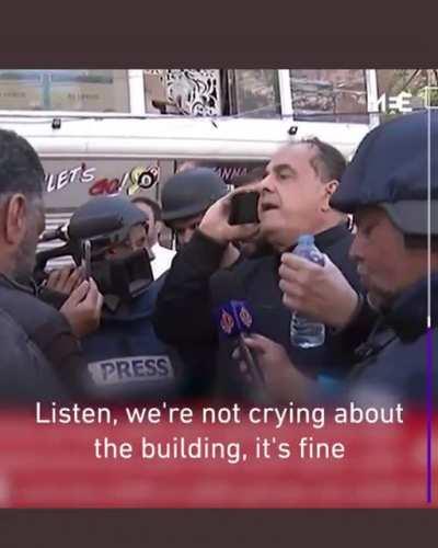 The owner of the Gaza media headquarters tower pleads with Israeli official on live TV to let journalists collect their gear. Moments later, air strikes demolish the building that housed several international media offices, including Associated Press.