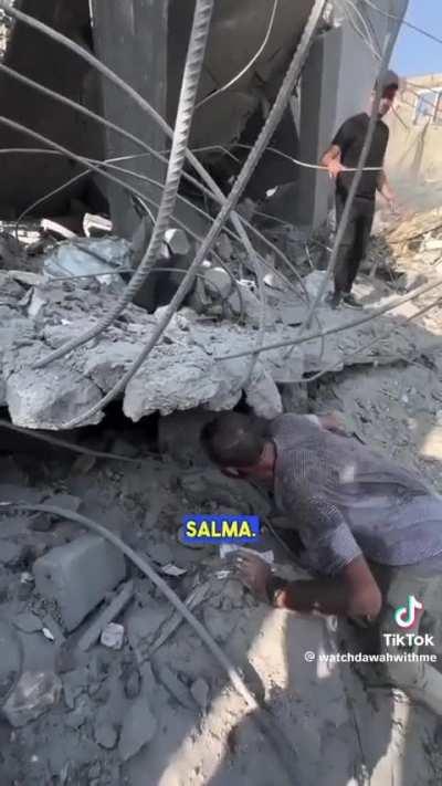 An emotionally shattered man looks for his four children under the rubble in Gaza.