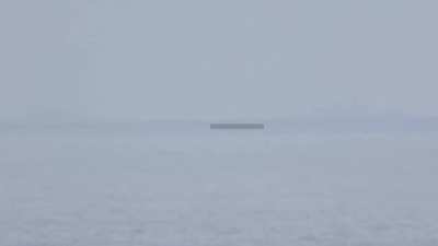 PLAN fleet of warships supposedly in visual range from Taiwan coastline with observer at under 200 meters elevation here above sea level.