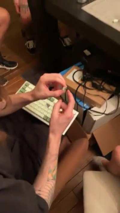 Newly ascended buddy showing off switches to a girl at his house party.