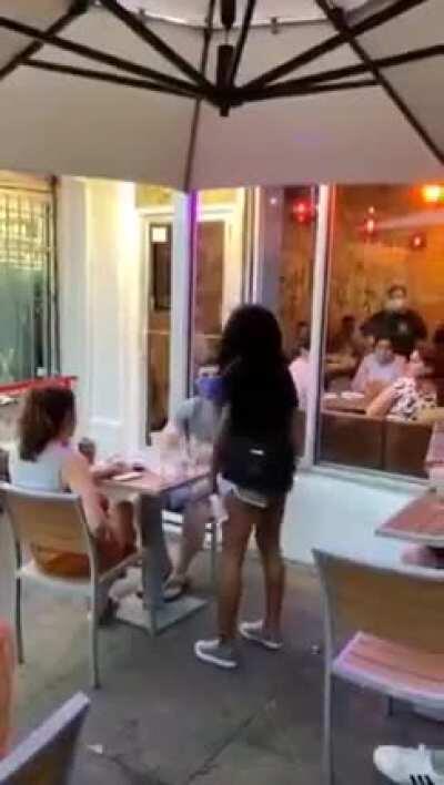 Group of protesters berate and harass a couple for not raising their arm in solidarity