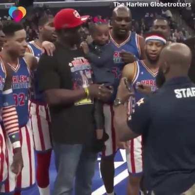 This 3-year-old girl posed for a photo with her dad and the Globetrotters... when she looked at the picture she saw her mom, who was deployed in Kuwait for 7 months