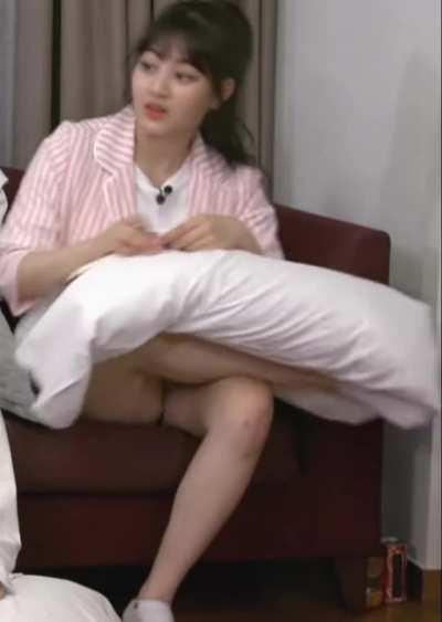 Jihyo - ponytail, white t-shirt, pink striped suit style jacket, writing on a pillow