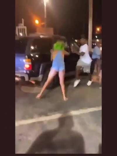 Guy tries to punch a woman but runs into a car instead
