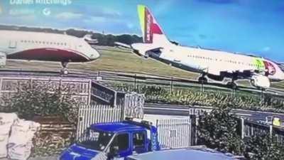 Small aircraft lands between too comercial jets somewhere in England (not sure where, sorry)