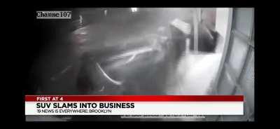 Van crashes into business