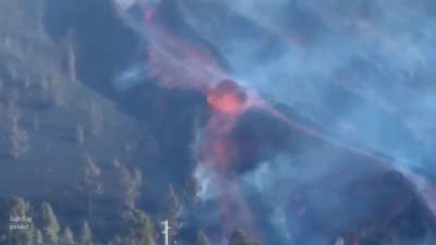 Colossal molten boulder rolls down the mountain in a river of lava