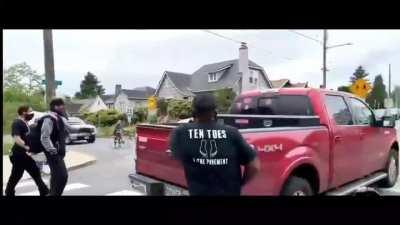 Standoff at the JFPK March in Portland, several demonstrators pointing weapons at an armed driver