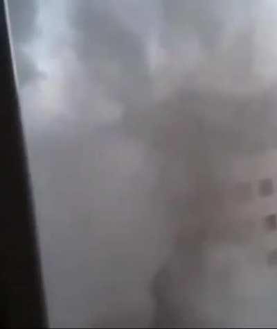 A Palestinian woman films the destruction of another apartment building, not knowing that the next strike is gonna be on where she lives.