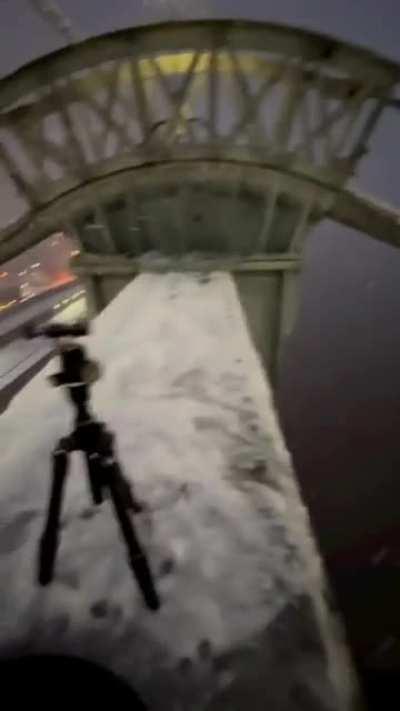 man seating on top of a bridge tower