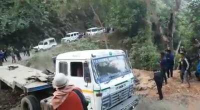 Excavator falls down a cliff, Driver jumps.