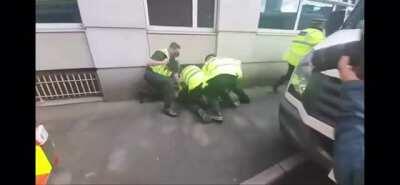 A police officer punches a Manchester United fan at the protest against Glazer ownership, outside Old Trafford