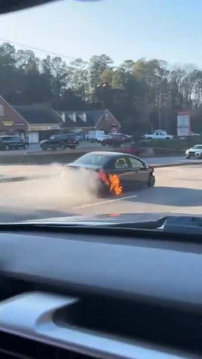Honda driving with flames coming from the rear wheel