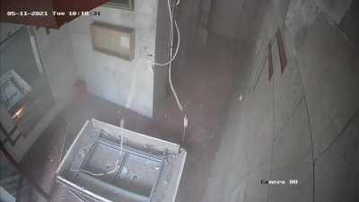 Two kids escape a collapsing ceiling after and Israeli airstrike on Gaza