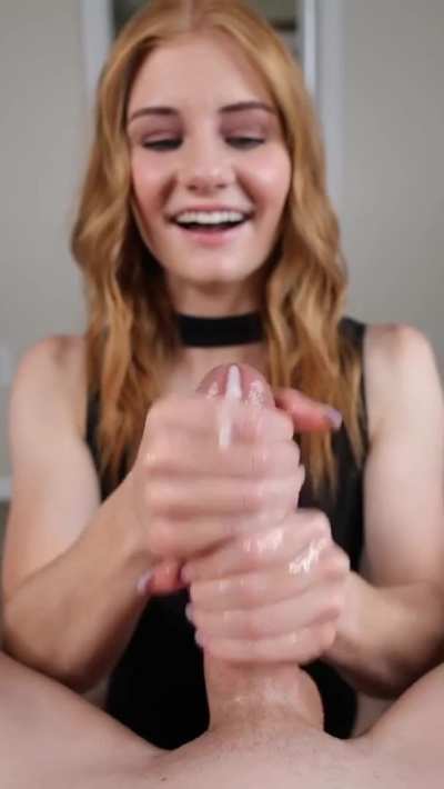 Cute Redhead Smiling While She Strokes Him
