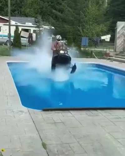 Riding a snowmobile across the family pool