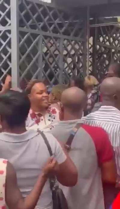 Crowd breaking into a bank in Nigeria.