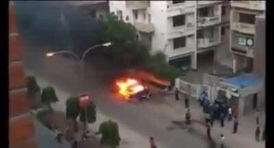 WCGW standing close to a burning vehicle.