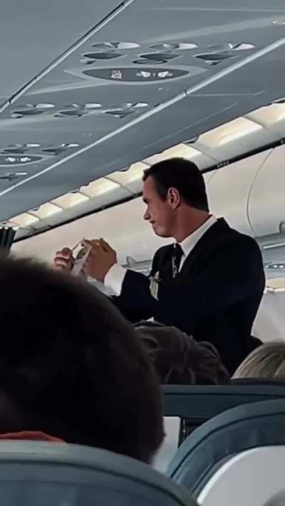 An Aeroflot flight attendant with the vibe of The Rock Johnson