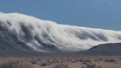 Cloud cascades seen tumbling over a mountain near Alkali Lake in Oregon.