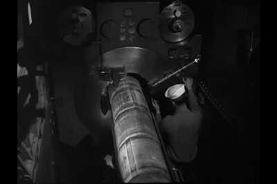 Hydraulic rammer loading a 16-inch/50-caliber Mark 7 gun on USS Missouri