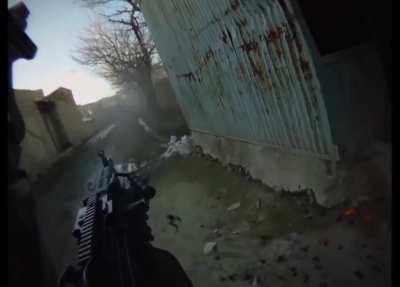 GoPro footage follows a M249 SAW gunner as he and US troops cross a small bridge and lay down suppressive fire. (Afghanistan, Date Unknown)