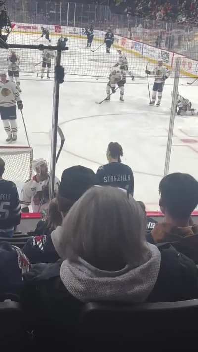 A guy wearing a Michael Myers costume at a hockey game, doesnt flinch when a playwrnslashes the glass