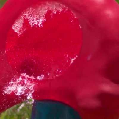 Water balloon getting obliterated by a baseball in slow mo