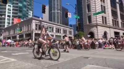 Naked Men and women riding naked infront of kids.