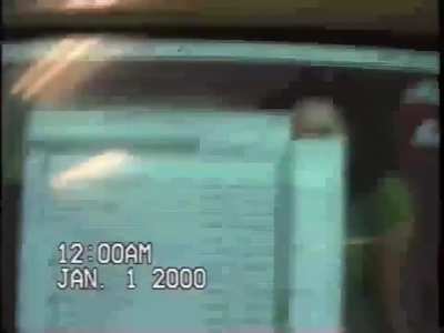 A guy checks his computer on New Year's night, 2000