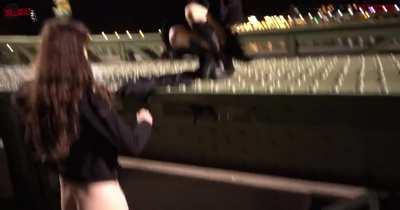 Friends in Public on a Bridge Between Passersby